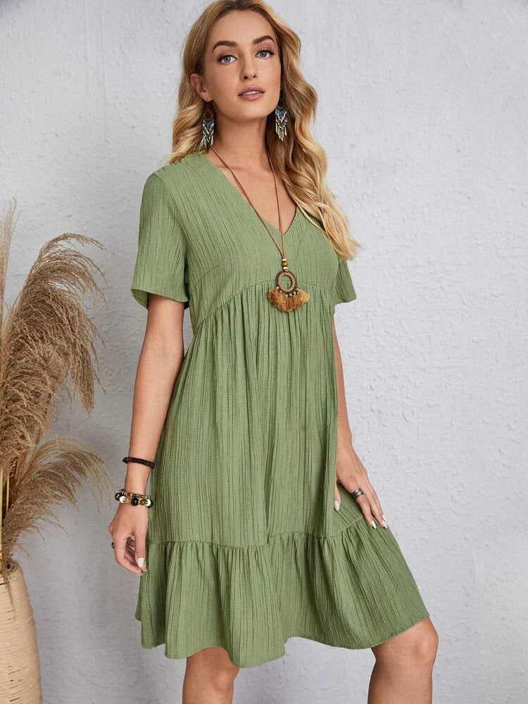 Flowy bohemian mini summer dress with a relaxed fit, perfect for warm weather and casual summer events.
