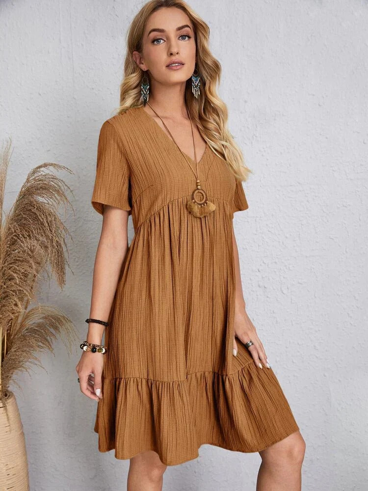 Flowy bohemian mini summer dress with a relaxed fit, perfect for warm weather and casual summer events.






