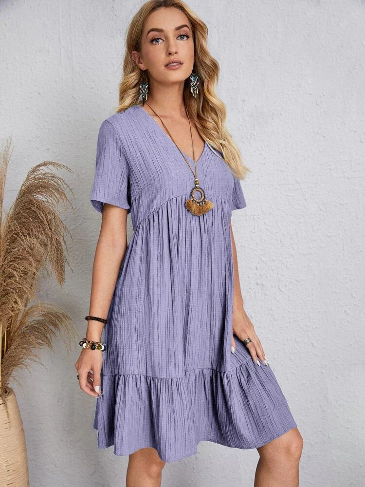 Flowy bohemian mini summer dress with a relaxed fit, perfect for warm weather and casual summer events.






