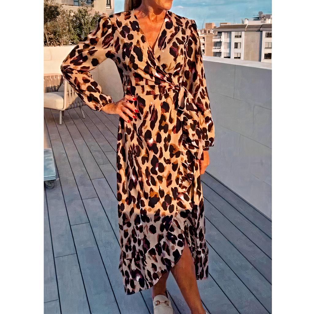 Woman wearing a stylish leopard print dress with a flowy silhouette, perfect for summer days.