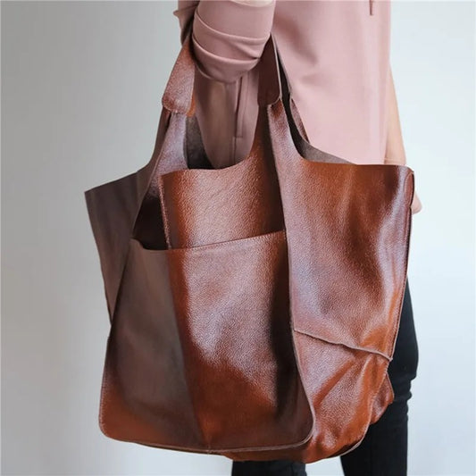  Women's elegant leather tote bag with spacious design, perfect for summer days and versatile everyday use.