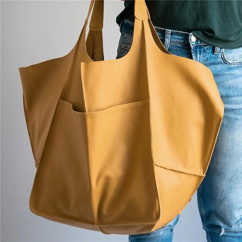  Women's elegant leather tote bag with spacious design, perfect for summer days and versatile everyday use.