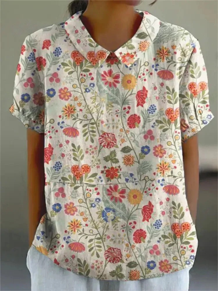 Women’s floral summer blouse with lightweight fabric, breathable design, and elegant floral pattern, perfect for warm weather and versatile styling.