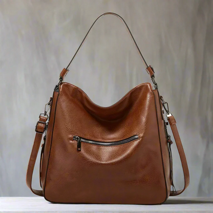 Women's vintage leather bag with a timeless design, spacious interior, and adjustable strap, ideal for both casual and formal use.






